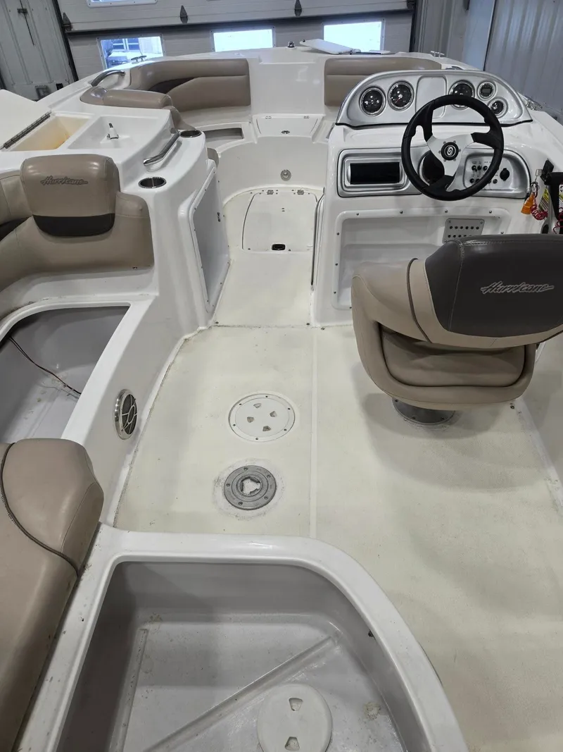 Slide: The Image of Interior of a 2013 Hurricane SS203-OB boat with steering wheel and seats. - 10