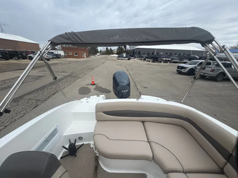 Slide: The Image of 2013 Hurricane SS203-OB boat with Bimini top and outboard motor. - 13