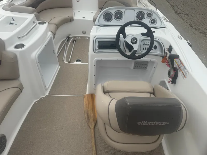 Slide: The Image of Interior of a 2013 Hurricane SS203-OB boat with steering wheel and paddle. - 22