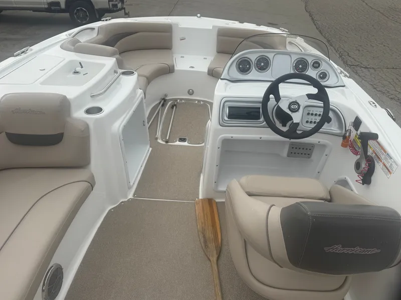 Slide: The Image of Interior of a 2013 Hurricane SS203-OB boat with steering wheel and seating. - 23