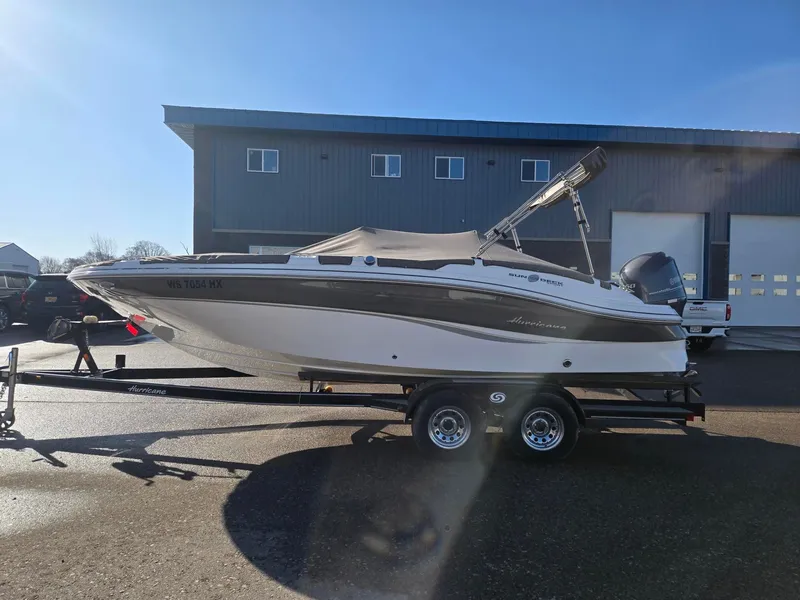 Slide: The Image of 2013 Hurricane SS203-OB boat on trailer in front of building. - 3