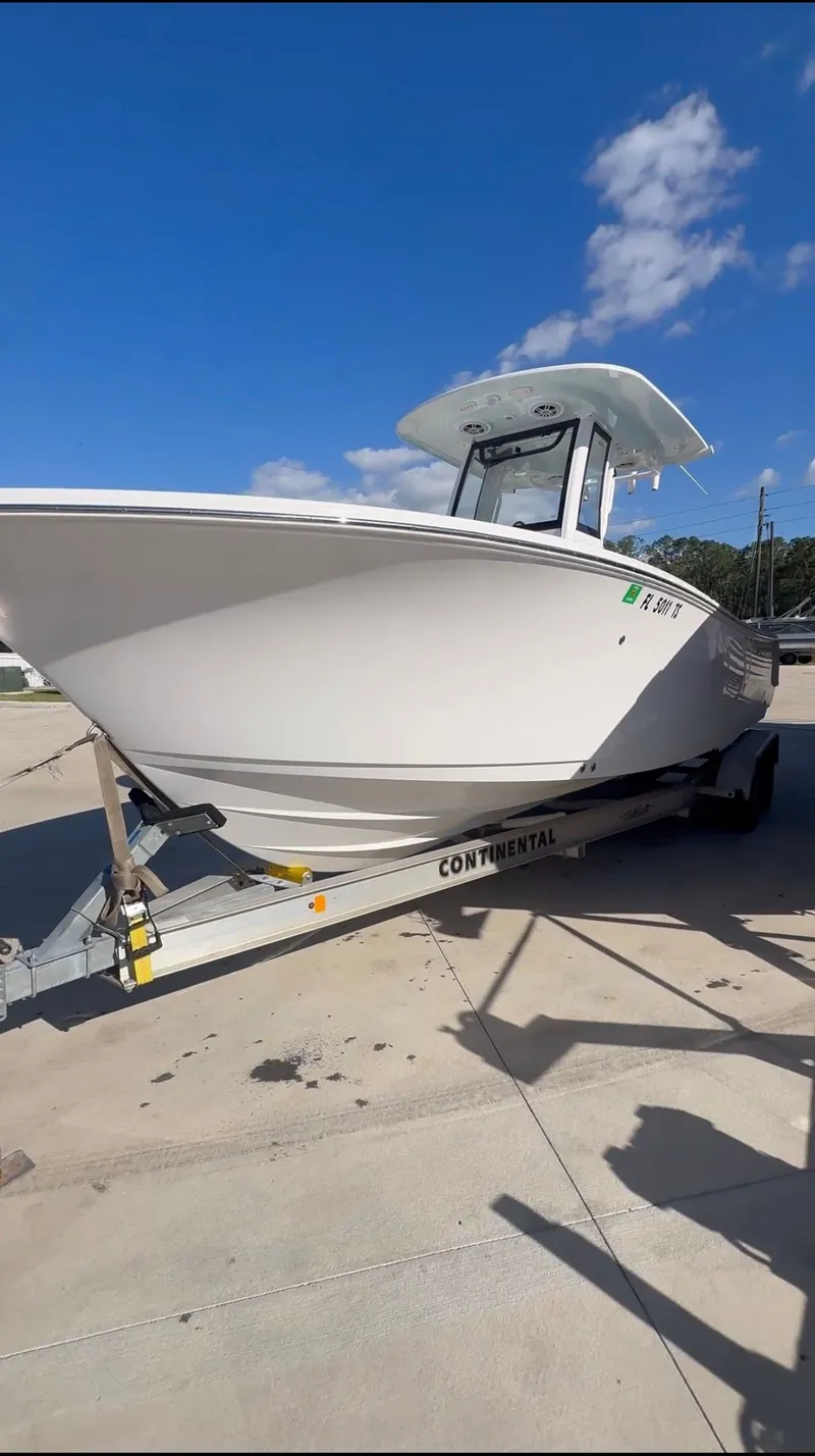 The Image of 2024 Sportsman Open 232 Center Console on trailer, blue sky. - 1