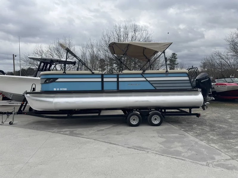 The Image of 2020 Crest 240 Platinum pontoon boat on trailer, cloudy sky. - 1