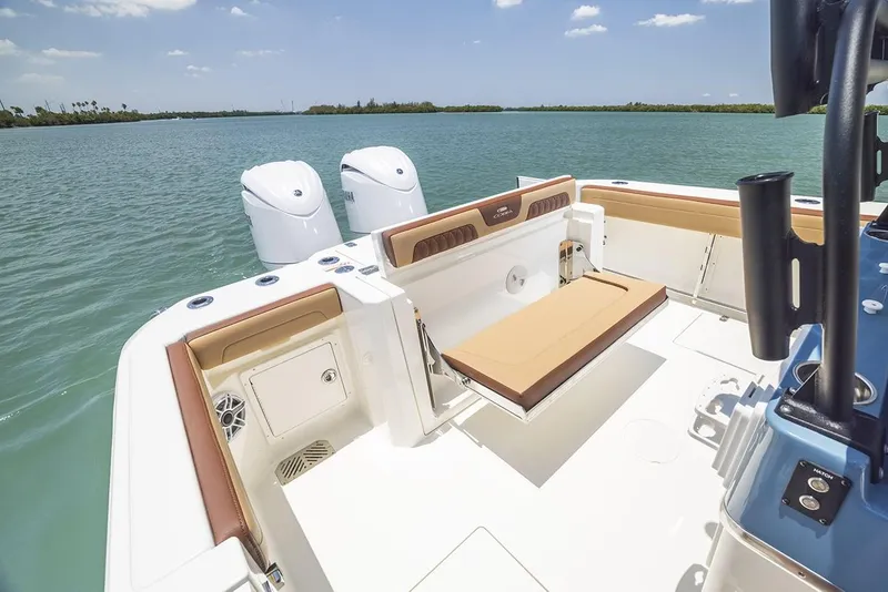 Slide: The Image of Manufacturer Provided Image: 2025 Cobia 265 Center Console Open boat on calm water, featuring dual engines and spacious deck. - 17