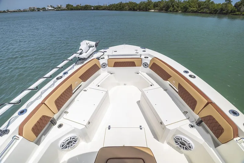Slide: The Image of Manufacturer Provided Image: 2025 Cobia 265 Center Console Open boat interior with seating, on calm water. - 2
