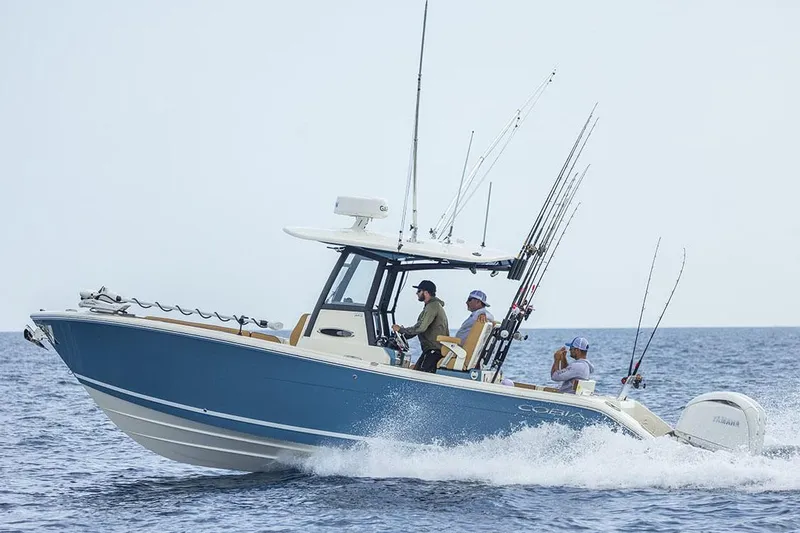 Slide: The Image of Manufacturer Provided Image: 2025 Cobia 265 Center Console Open boat cruising on the ocean. - 8