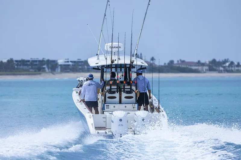 Slide: The Image of Manufacturer Provided Image: 2025 Cobia 265 Center Console Open cruising on blue ocean waters. - 9