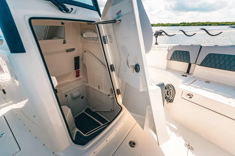 Slide: The Image of Manufacturer Provided Image: 2025 Cobia 285 Open Center Console boat interior with open storage compartment. - 10