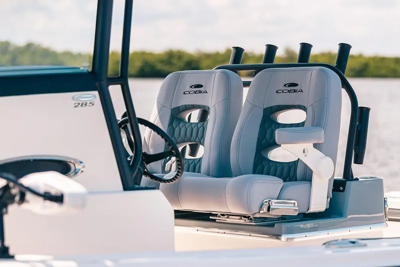 Slide: The Image of Manufacturer Provided Image: 2025 Cobia 285 Open Center Console boat seats with steering wheel. - 12
