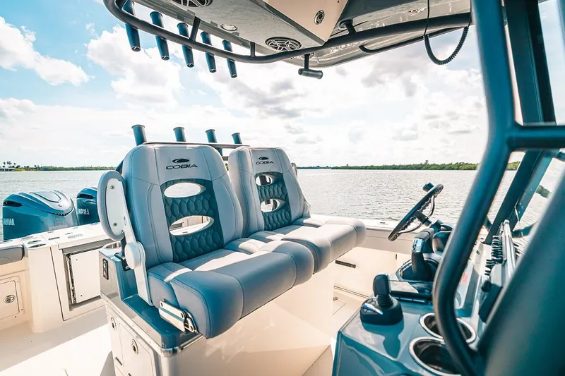 Slide: The Image of Manufacturer Provided Image: 2025 Cobia 285 Open Center Console boat interior with dual seats and steering console. - 13