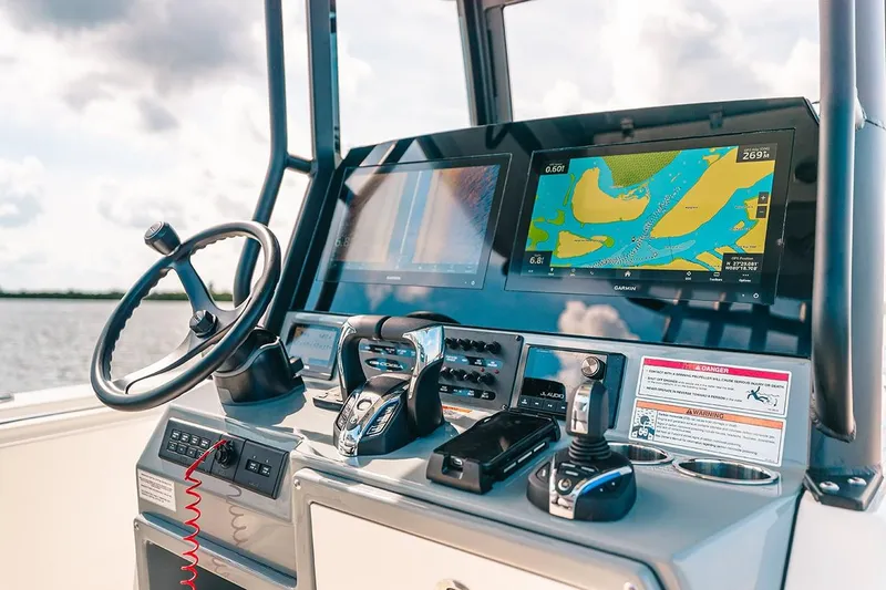 Slide: The Image of Manufacturer Provided Image: 2025 Cobia 285 Open Center Console dashboard with navigation screens and controls. - 14