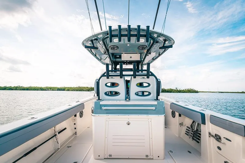 Slide: The Image of Manufacturer Provided Image: 2025 Cobia 285 Open Center Console boat on calm water, clear sky. - 15