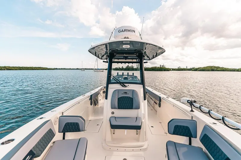 Slide: The Image of Manufacturer Provided Image: 2025 Cobia 285 Open Center Console boat on calm water. - 3