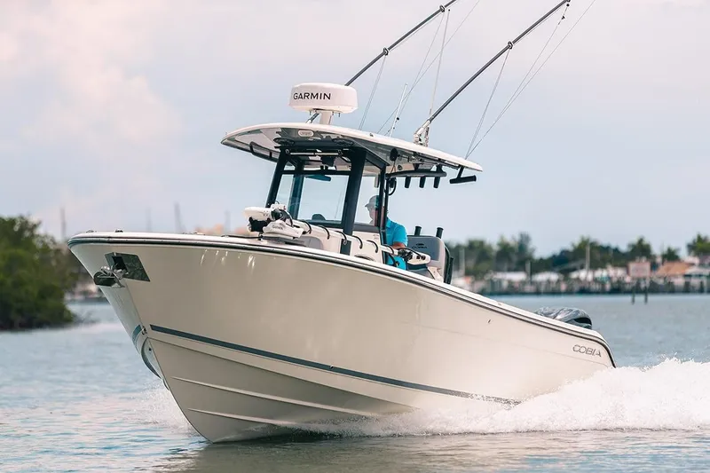 Slide: The Image of Manufacturer Provided Image: 2025 Cobia 285 Open Center Console boat cruising on water. - 4