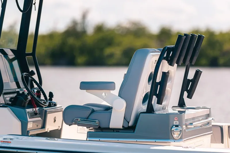 Slide: The Image of Manufacturer Provided Image: 2025 Cobia 285 Open Center Console boat interior with seating and rod holders. - 9