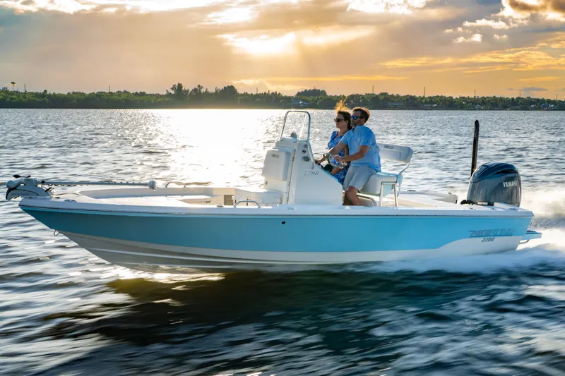Slide: The Image of Manufacturer Provided Image: 2026 Pathfinder 2200 TRS boat cruising on a serene lake at sunset. - 0