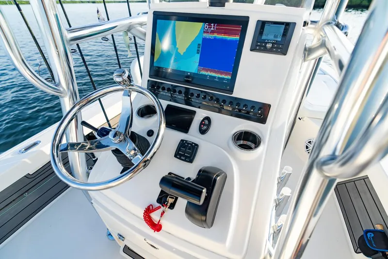 Slide: The Image of Manufacturer Provided Image: 2026 Pathfinder 2200 TRS boat console with steering wheel and navigation display. - 15