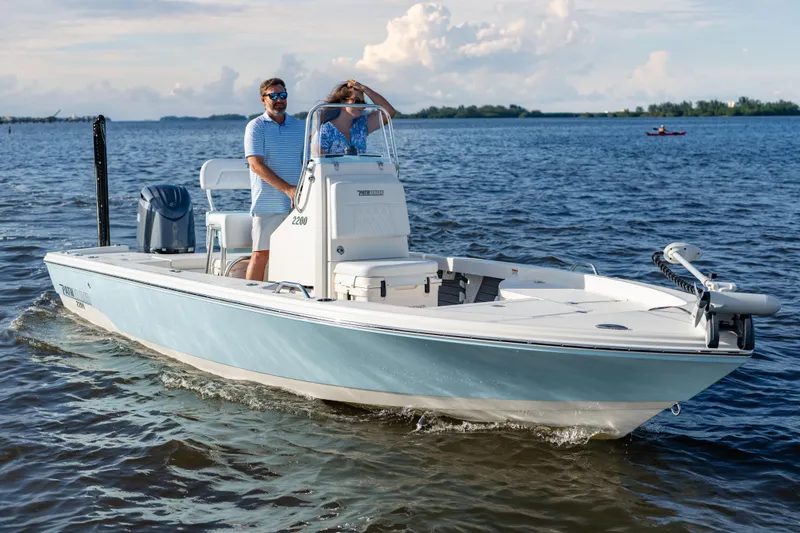 Slide: The Image of Manufacturer Provided Image: 2026 Pathfinder 2200 TRS boat cruising on a sunny day with two passengers. - 2