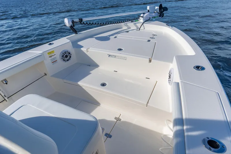 Slide: The Image of Manufacturer Provided Image: 2026 Pathfinder 2400 Open boat interior with seating and storage, on calm water. - 2