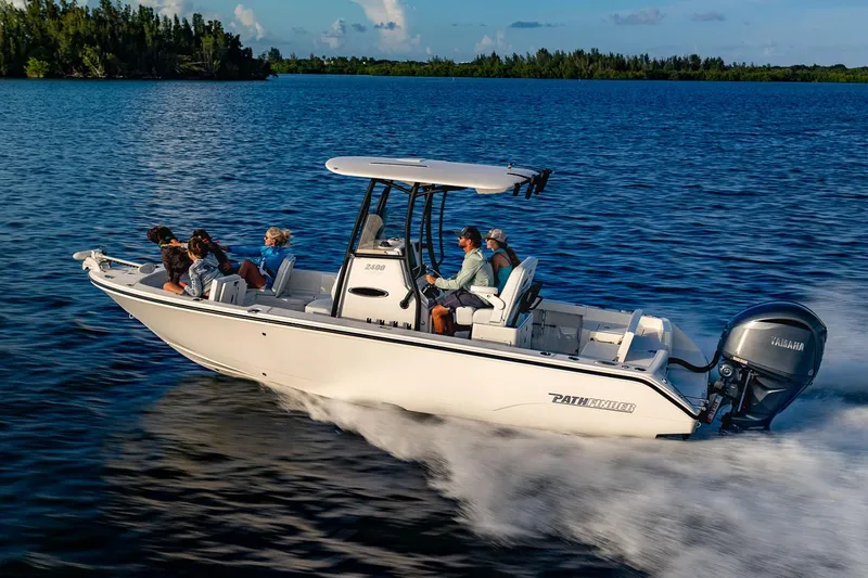 Slide: The Image of Manufacturer Provided Image: 2026 Pathfinder 2400 TRS boat cruising on a serene lake with passengers. - 0