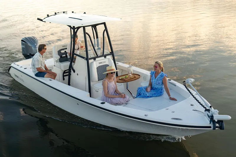 Slide: The Image of Manufacturer Provided Image: 2026 Pathfinder 2400 TRS boat cruising with passengers on calm water. - 1