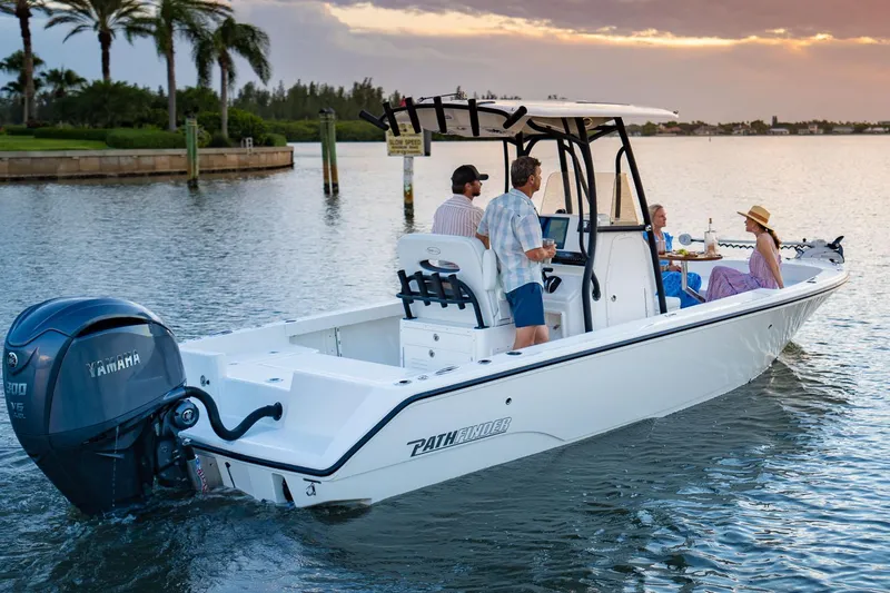 Slide: The Image of Manufacturer Provided Image: 2026 Pathfinder 2400 TRS boat cruising on a serene lake at sunset with passengers. - 2