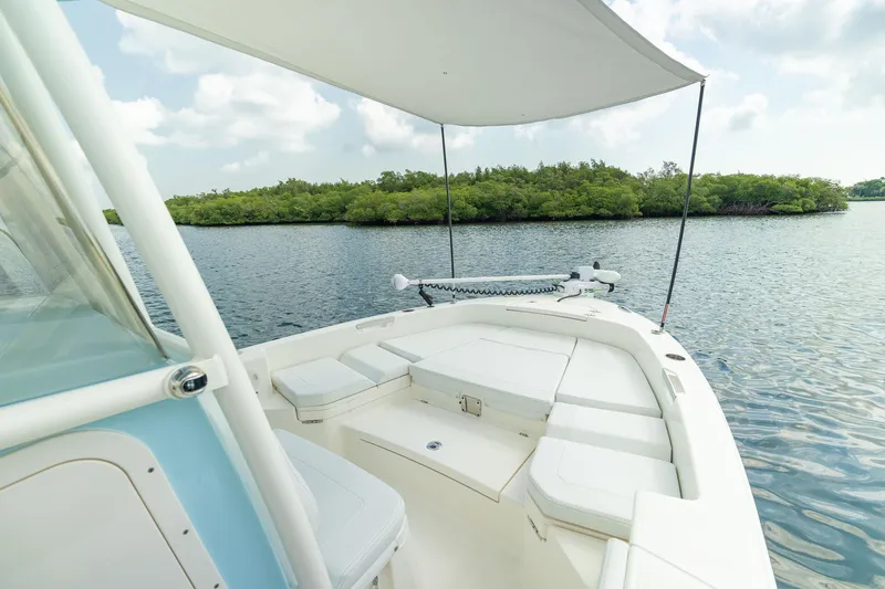 Slide: The Image of Manufacturer Provided Image: Pathfinder 2400 TRS boat on water, 2026 model, with canopy and scenic view. - 6