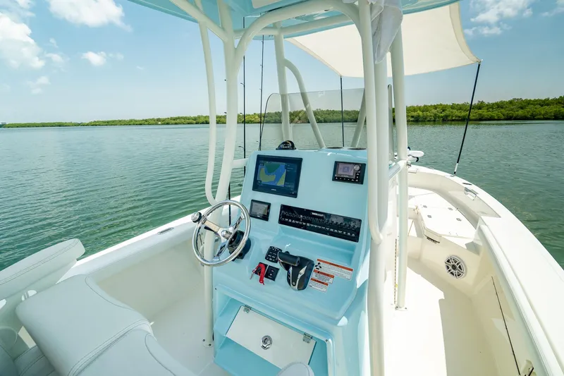Slide: The Image of Manufacturer Provided Image: 2026 Pathfinder 2400 TRS boat interior with modern navigation system on calm water. - 9