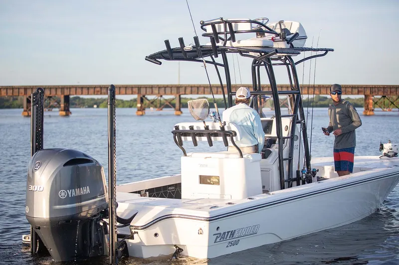 Slide: The Image of Manufacturer Provided Image: 2026 Pathfinder 2500 Hybrid boat on water, featuring Yamaha 300 engine, with two people onboard. - 2