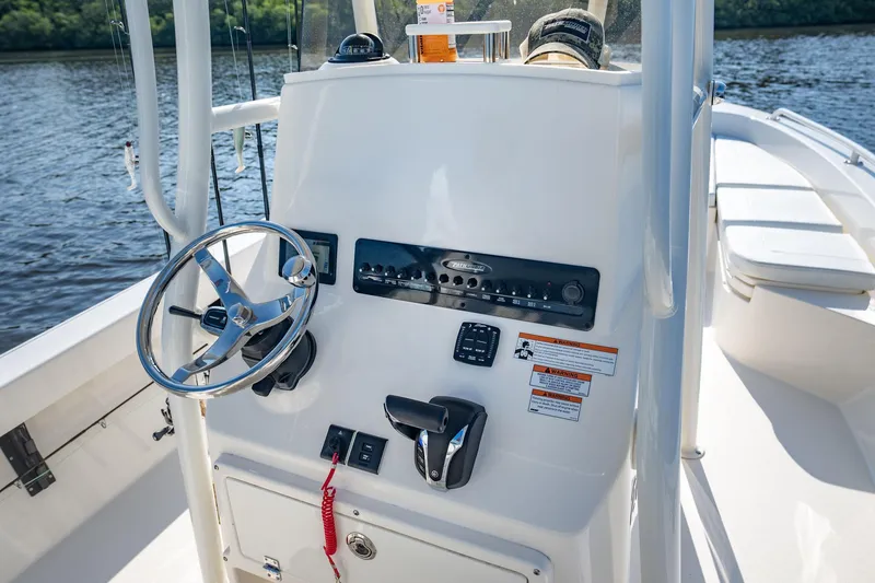 Slide: The Image of Manufacturer Provided Image: 2026 Pathfinder 2600 TRS boat console with steering wheel and controls on a sunny day. - 10