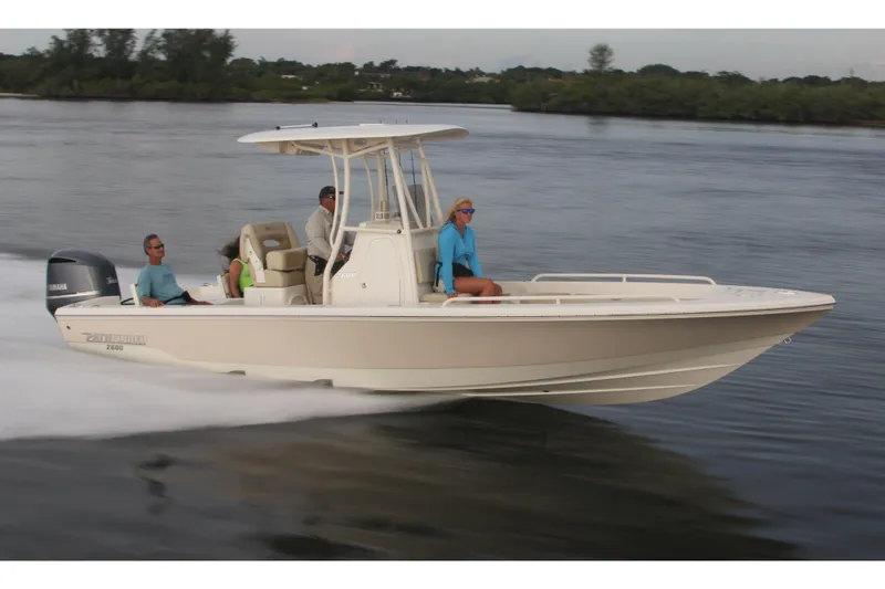 Slide: The Image of Manufacturer Provided Image: 2026 Pathfinder 2600 TRS boat cruising on water with passengers, showcasing sleek design and performance. - 3