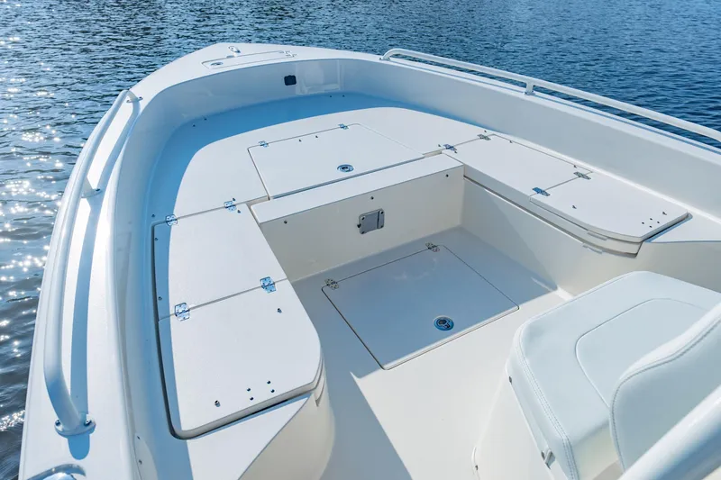 Slide: The Image of Manufacturer Provided Image: 2026 Pathfinder 2600 TRS boat deck with storage compartments on calm water. - 4