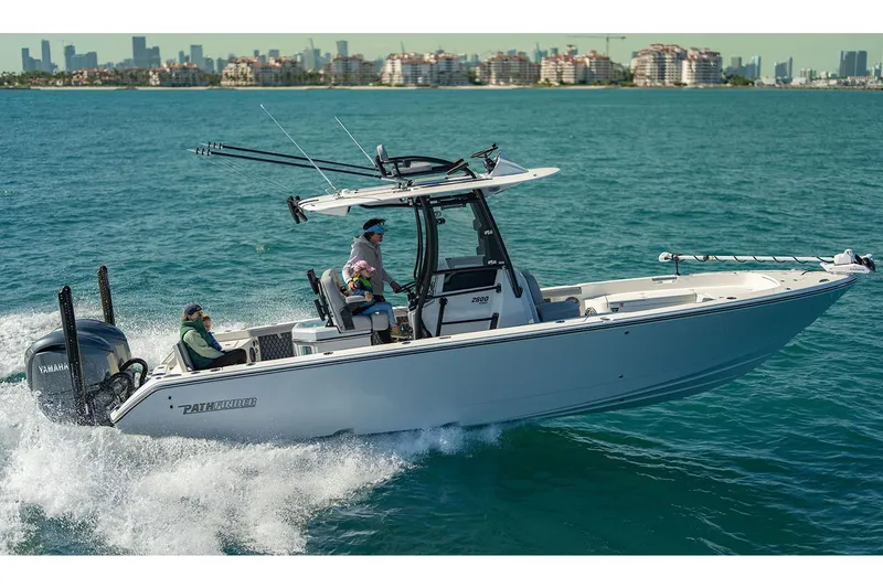 Slide: The Image of Manufacturer Provided Image: 2026 Pathfinder 2800 Hybrid boat cruising on blue ocean near city skyline. - 4