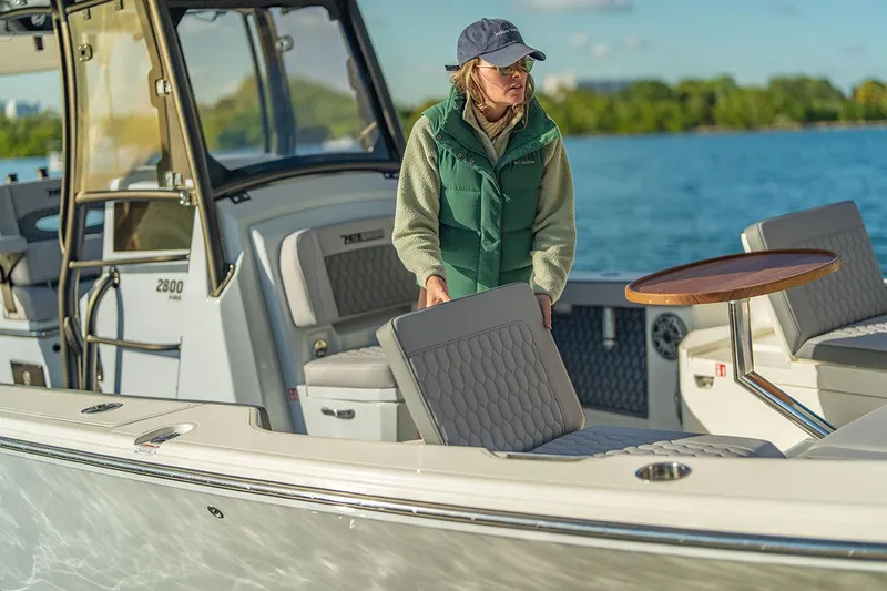 Slide: The Image of Manufacturer Provided Image: Woman on 2026 Pathfinder 2800 Hybrid boat, enjoying a sunny day on the water. - 6