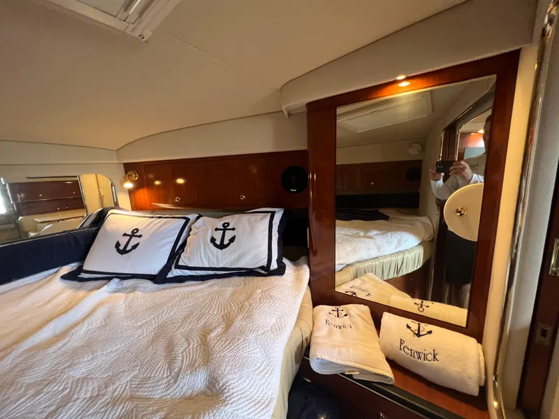 Slide: The Image of Interior of 2001 Sea Ray 340 Amberjack with nautical-themed bedding. - 22