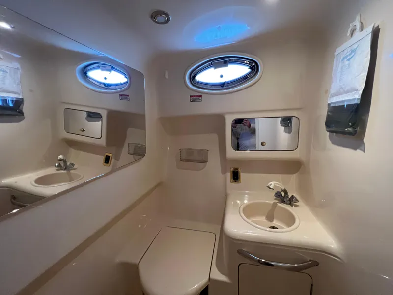 Slide: The Image of Sea Ray 340 Amberjack 2001 bathroom with sink and mirror. - 24