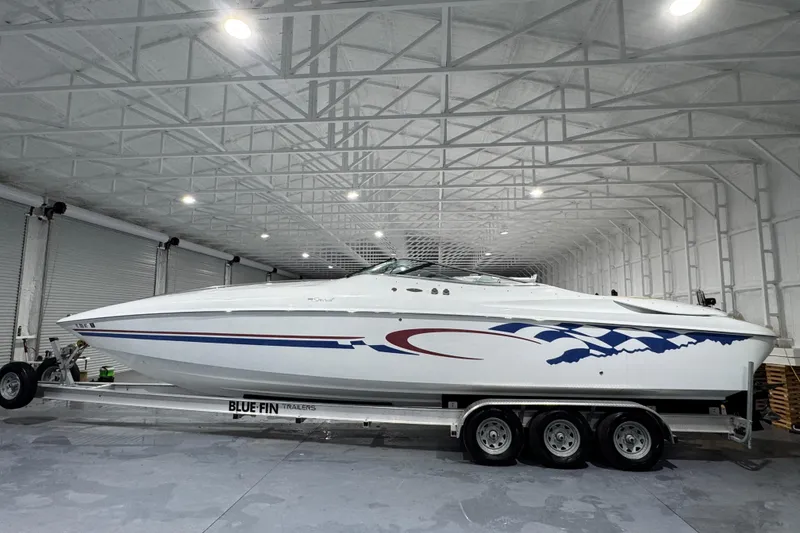 Slide: The Image of 2002 Baja .38 Special boat on trailer in spacious indoor storage. - 1