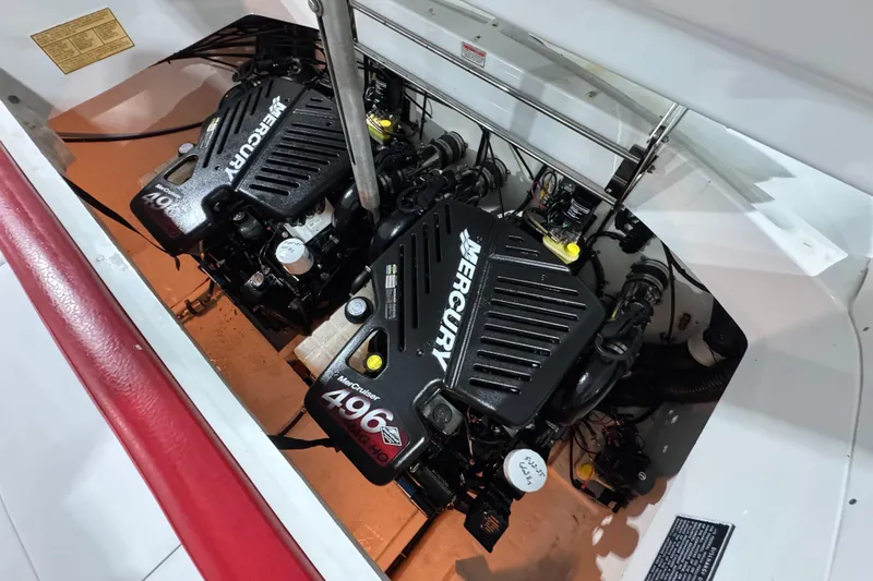 Slide: The Image of Twin Mercury engines in a 2002 Baja .38 Special boat engine compartment. - 12