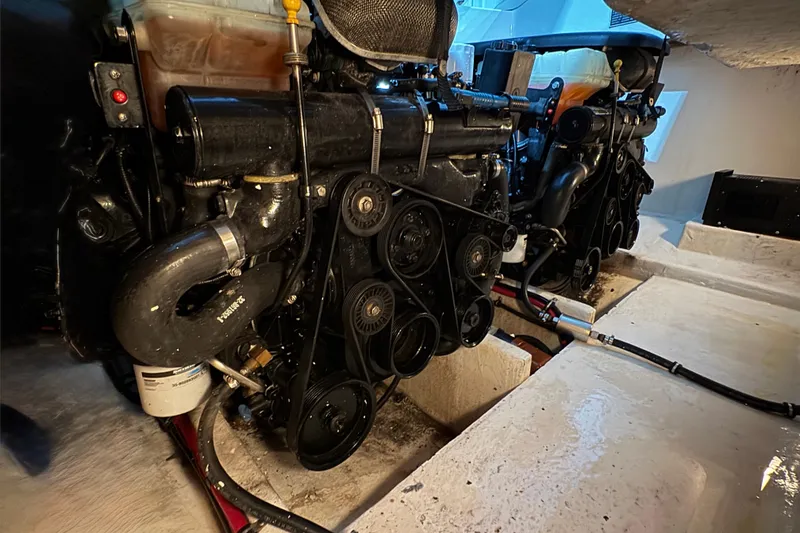 Slide: The Image of Engine room of a 2002 Baja .38 Special boat, featuring dual engines and mechanical components. - 13