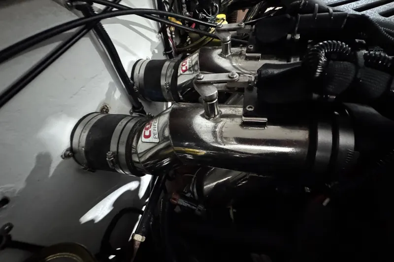 Slide: The Image of Engine components of a 2002 Baja .38 Special boat, featuring polished metal parts. - 14