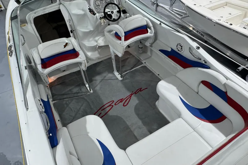 Slide: The Image of 2002 Baja .38 Special boat interior with white, red, and blue seating. - 17