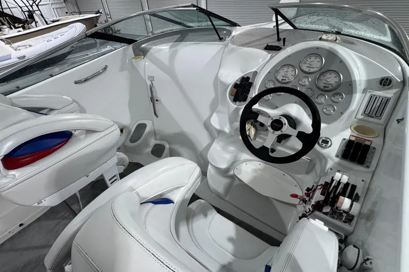 Slide: The Image of 2002 Baja .38 Special boat cockpit with white leather seats and modern dashboard controls. - 18