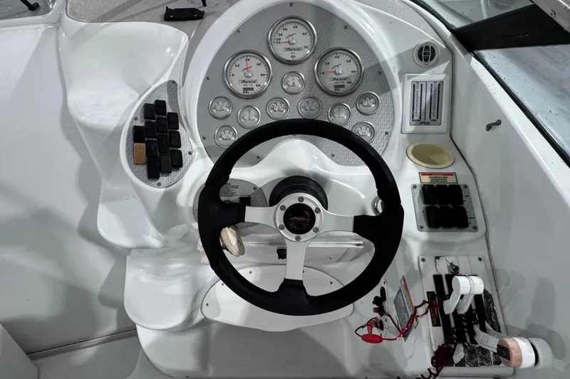 Slide: The Image of Cockpit of a 2002 Baja .38 Special boat with steering wheel and gauges. - 19