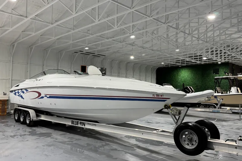 Slide: The Image of 2002 Baja .38 Special boat on trailer in spacious indoor storage facility. - 2