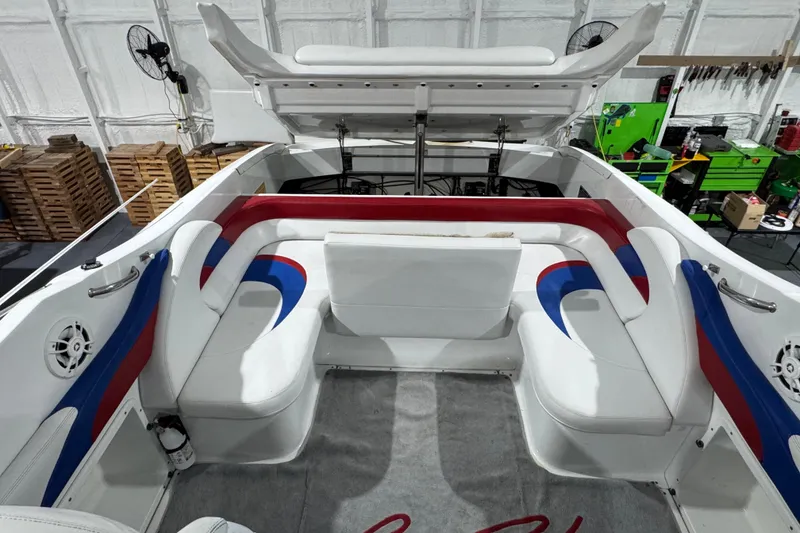 Slide: The Image of Interior of a 2002 Baja .38 Special boat with white, red, and blue seating. - 20