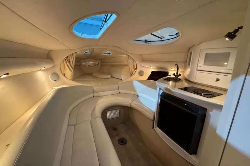 Slide: The Image of Interior of a 2002 Baja .38 Special boat with seating, kitchenette, and portholes. - 21