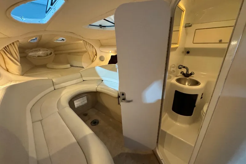 Slide: The Image of Interior of a 2002 Baja .38 Special boat with seating and compact bathroom. - 22