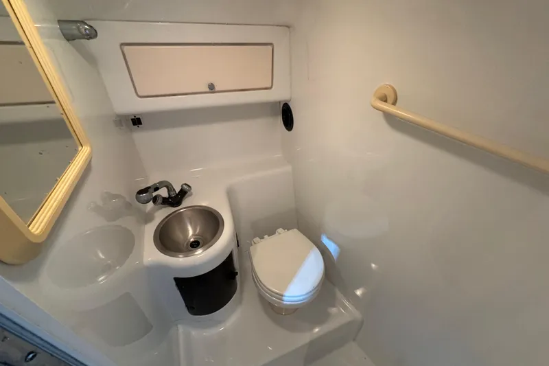 Slide: The Image of Compact bathroom in a 2002 Baja .38 Special boat. - 24