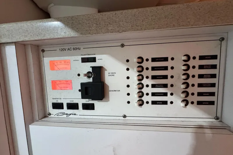 Slide: The Image of Electrical control panel of a 2002 Baja .38 Special boat, featuring various switches and indicators. - 25