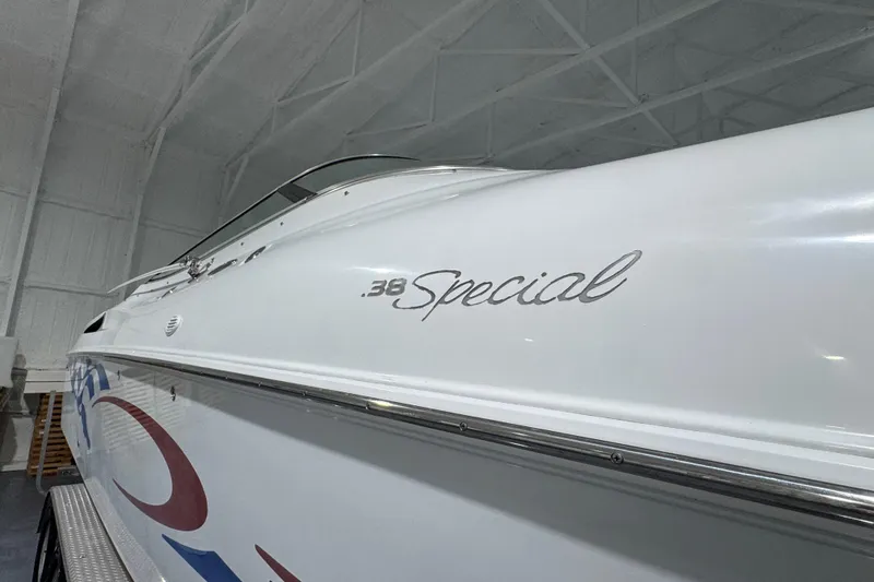 Slide: The Image of 2002 Baja .38 Special boat in a white indoor storage facility. - 30